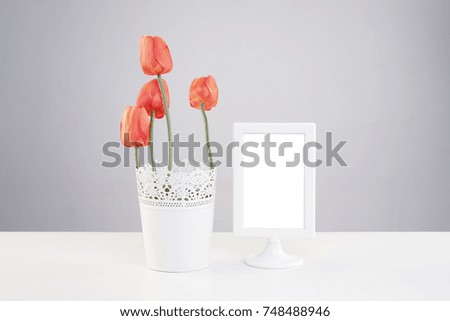Beautiful orange tulip flowers and a photo frame.