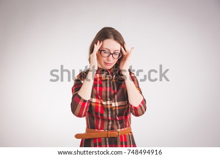 Headache. Unhappy business women in glasses standing over grey background