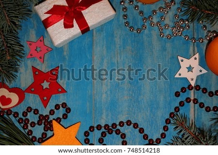 beautiful Christmas background with fir twigs and gift on blue wooden boards