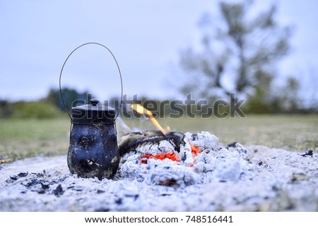 The container on the coals to make tea during the journey.