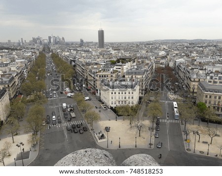 View from the triumphal arch to the streets of spring Paris streets under the gray sky