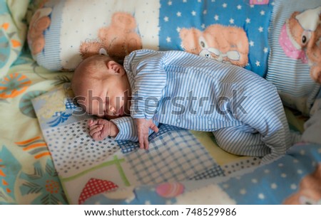 A baby newborn is sleeping