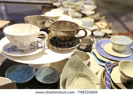 ceramic pot shop ,turquoise glazed ceramic pitchers in green shelf ,