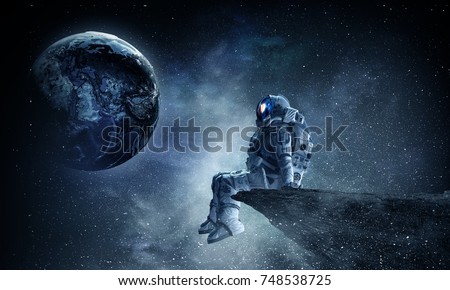 Spaceman on rock edge. Mixed media Royalty-Free Stock Photo #748538725
