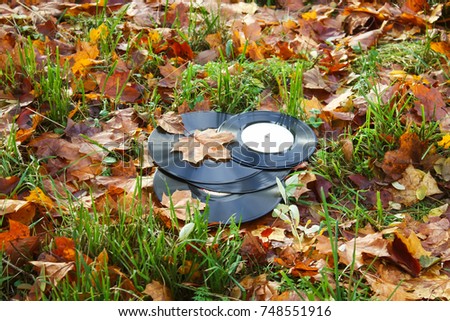 Vintage vinyl records on fall autumn leaves background.