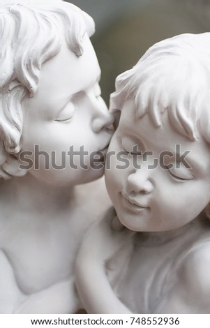 Couple cupids sculpture. Wedding and valentine background. Royalty-Free Stock Photo #748552936