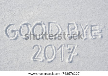 Goodbye 2017 text letters handwritten on flat snow surface. New year holiday seasonal postcard, greeting card.