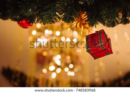 Beautiful decorated Christmas tree background with pink gift box and xmas ornaments