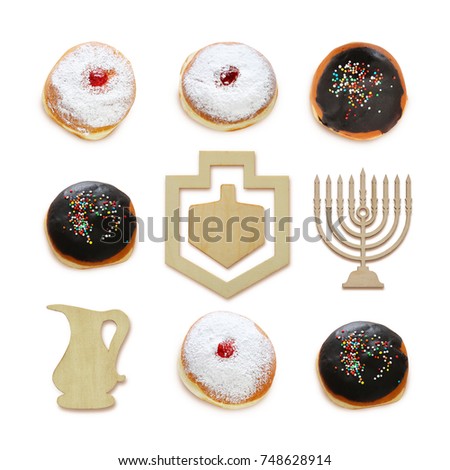 jewish holiday Hanukkah image with traditional doughnuts and menorah (traditional candelabra) isolated on white