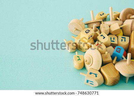 Image of jewish holiday Hanukkah with wooden dreidels colection (spinning top) on the table.