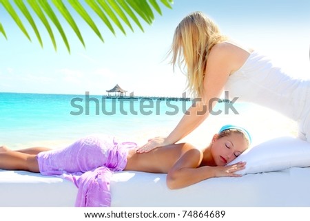 Caribbean turquoise beach chiropractic massage therapy woman [Photo Illustration]