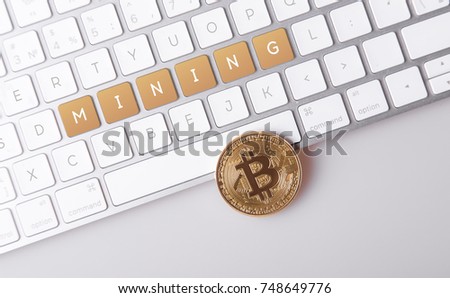gold coin bitcoin on the computer keyboard