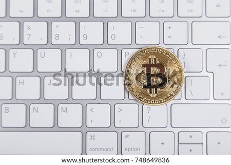 gold coin bitcoin on the computer keyboard