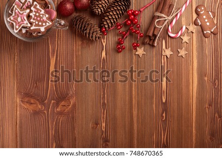 Christmas decor with gingerbreads on a wooden background with copy space for text. Top view. For greeting card.