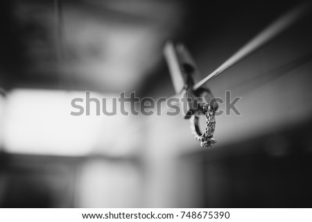 wedding ring hangs on the clothespin