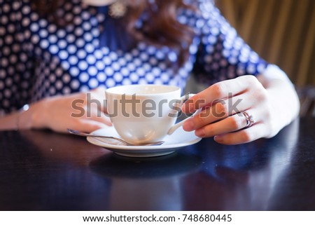 Woman's hands holding a cup, selective focus