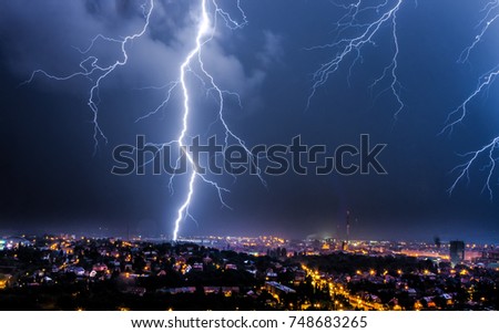 Thunderstorms and lightning over the night city.