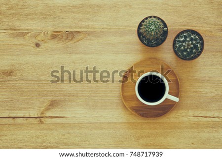 top view image of cup of coffee on wooden table