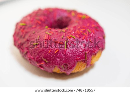 donut covered with red icing.