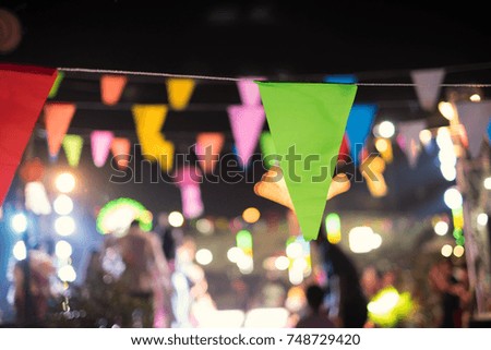 Colorful flag (green, red, pink, yellow,blue color) festival celebrate in garden blurred background. Night party christmas and happy new year concept.