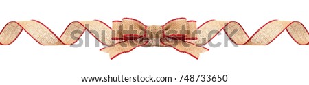 Long Christmas border with burlap bow and ribbon with red trim isolated on a white background