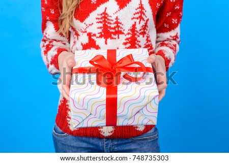 Concept of buying present on at Christmas and New Year. Cropped photo of woman's hands holding big wonderful Christmas present.