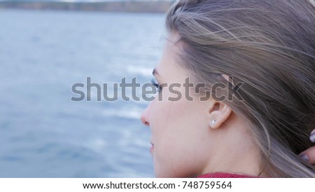 Closeup of beautiful girl at lake background. exy female model in trendy sun glasses a background of lake. Relaxing young woman in nature