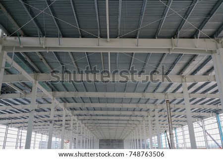 Steel structure roof truss with metal roof sheet under the construction building in the factory with blue sky