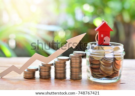 coins money setting growth up increase to house model for concept investment mortgage finance and home loan business  Royalty-Free Stock Photo #748767421