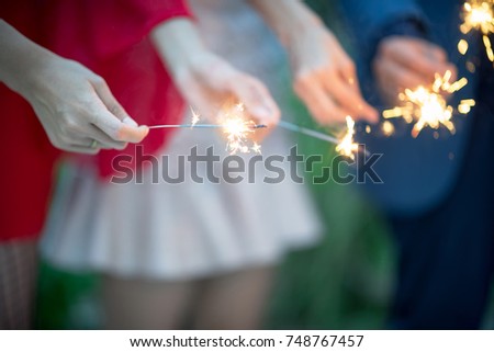 Blurry of hands with firework.Picture showing group of friends having fun with sparklers