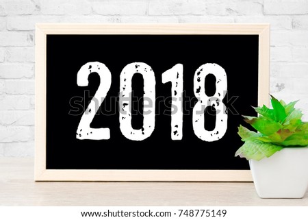 2018 on vintage chalkboard background, new year greeting card, sign board