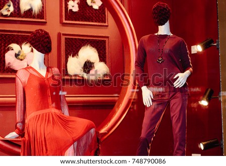 Fancy clothing on mannequins in a store in European shops. Display of a clothing store, bright and fashionable window of modern fashion. Beautiful clothing in a luxury store window. Sale for people