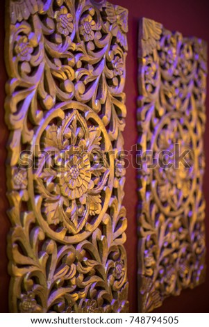 Wall decoration. A carved pattern of wood in gold.