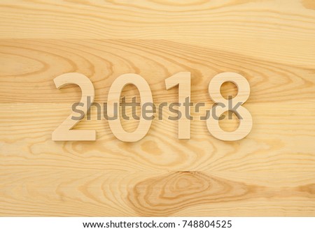 Wooden figures forming 2018, carved from light wood on the background of old wood. New Year Idea, postcard, poster, greetings. Festive decor.