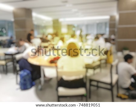 blurred image of teamwork people concept.Young team of coworkers making great business discussion in modern coworking space office and talking with partners while showing new startup idea monitor