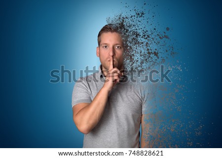 Man holds finger on his mouth while disintegration Royalty-Free Stock Photo #748828621