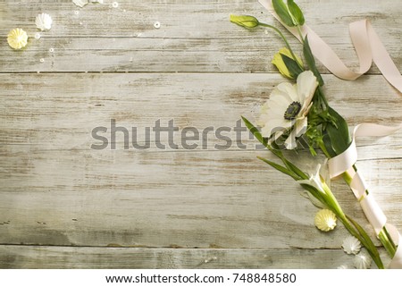 Beautiful flower on grunge wooden table. Romantic spring background. rustic table Image filtered retro style; romantic vintage. Eustoma, Anemóne, Ranúnculus, Gladioli, peonies, marshmallows, beads
