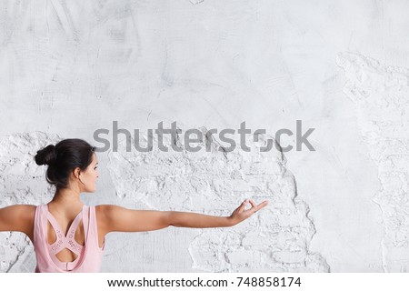 Image of woman hand in prana mudra. Gesture is on white brick wall background.. Yoga and healthy lifestyle concept Royalty-Free Stock Photo #748858174