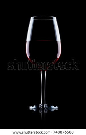Glass of red wine on black background with reflection