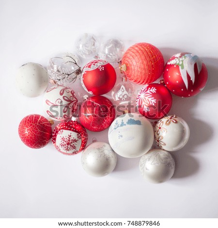 Red and white Christmas balls on a white background with different pictures on them. Christmas and New Year concept