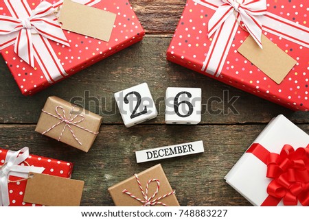 Boxing Day Concept. Different kinds of gift boxes on wooden background Royalty-Free Stock Photo #748883227