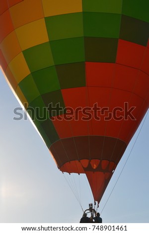 Beautiful hot air balloon close up macro photography portrait made of a colorful rainbow palette square texture pattern with a blue sky