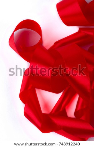 Red satin ribbon for decoration. Scroll of red satin ribbon on white background close up. Elegant decorative ribbon.