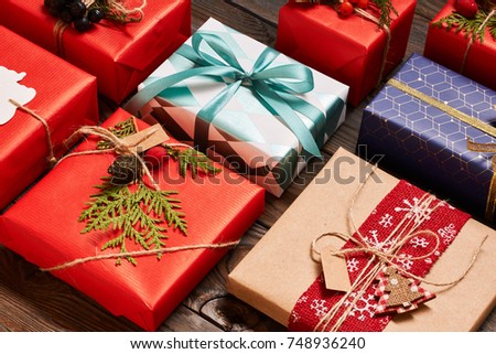 Creatively wrapped and decorated christmas presents in boxes on wooden background.Top view from above. Flat lay. 