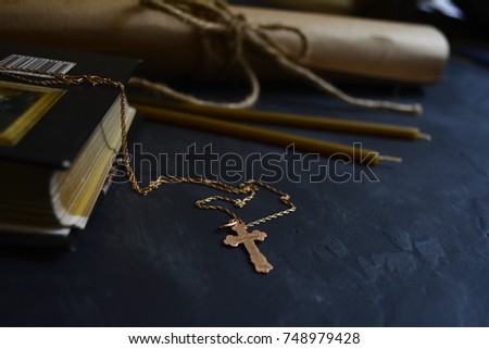Holy Scriptures , gold cross, and wax candles for the religious rite in Christianity , symbols of Christianity