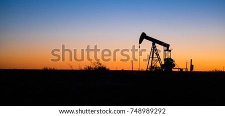 Texas Oil Pump Jack Fracking Crude Extraction Machine Sunset Royalty-Free Stock Photo #748989292