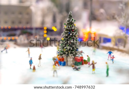 Christmas tree. People skate around the tree.