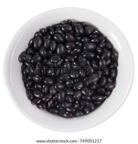 Phaseolus vulgaris is scientific name of Black Turtle Bean legume. Also known as Frijoles Negros and Feijao Preto. Top view of grains on ceramics bowl.