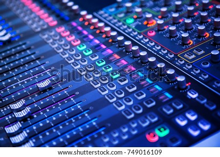 Professional sound and audio mixer control panel with buttons and sliders Royalty-Free Stock Photo #749016109