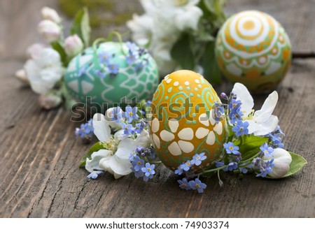 Basket full of Easter eggs and spring flower Royalty-Free Stock Photo #74903374